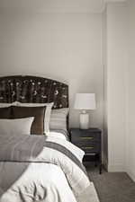 Bedroom featuring carpet and baseboards