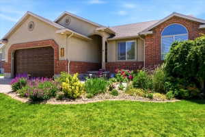 Front exterior featuring brick and stucco siding