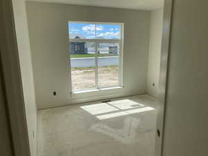 Room featuring a large window with white trim, capturing natural light
