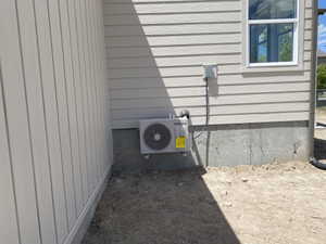 New exterior air conditioning unit installed on a concrete foundation
