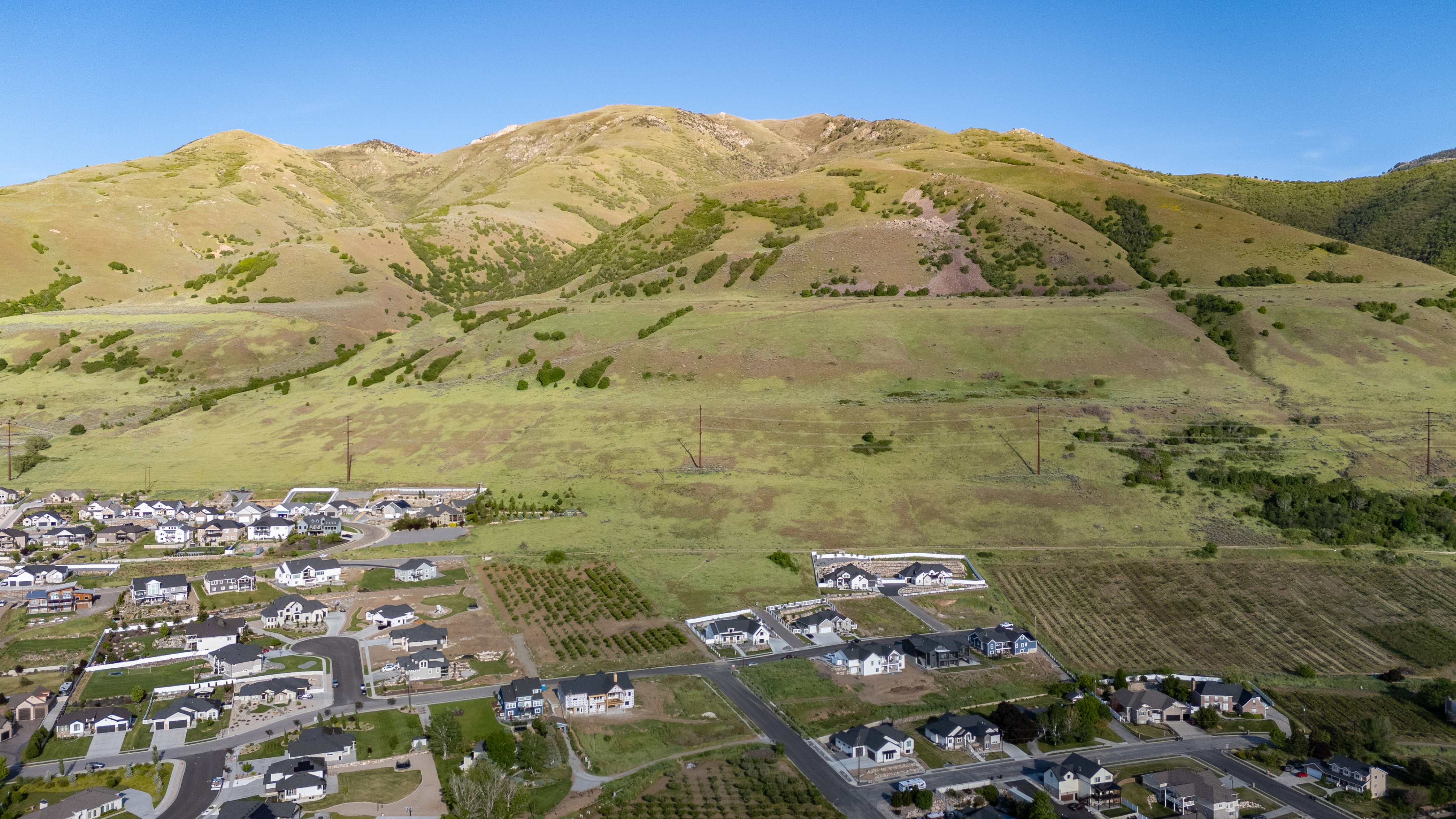 Expansive aerial perspective showcasing a developing residential community with varied home designs and established street grids