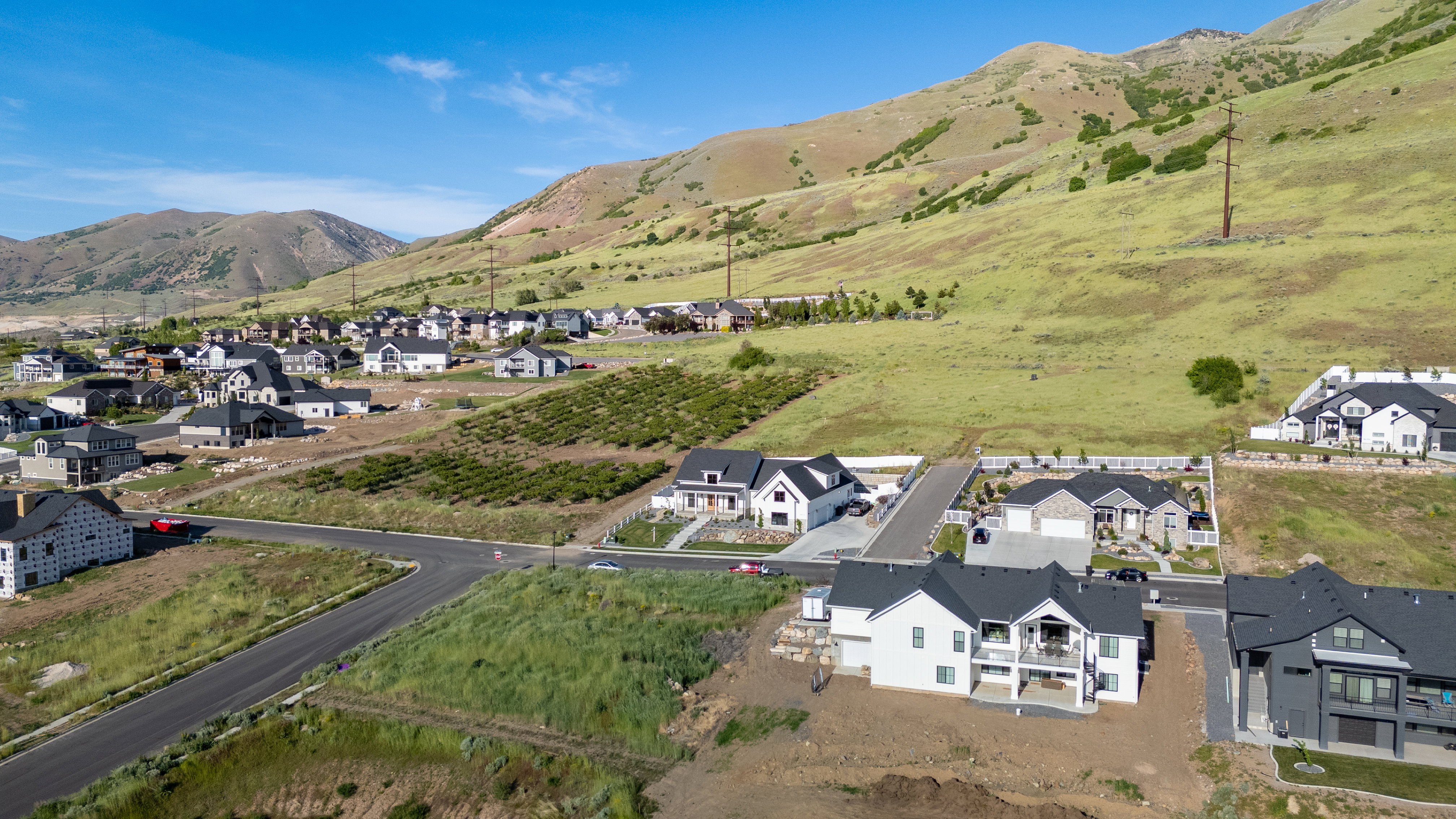 New construction residences situated on hillside lots with mountain backdrop