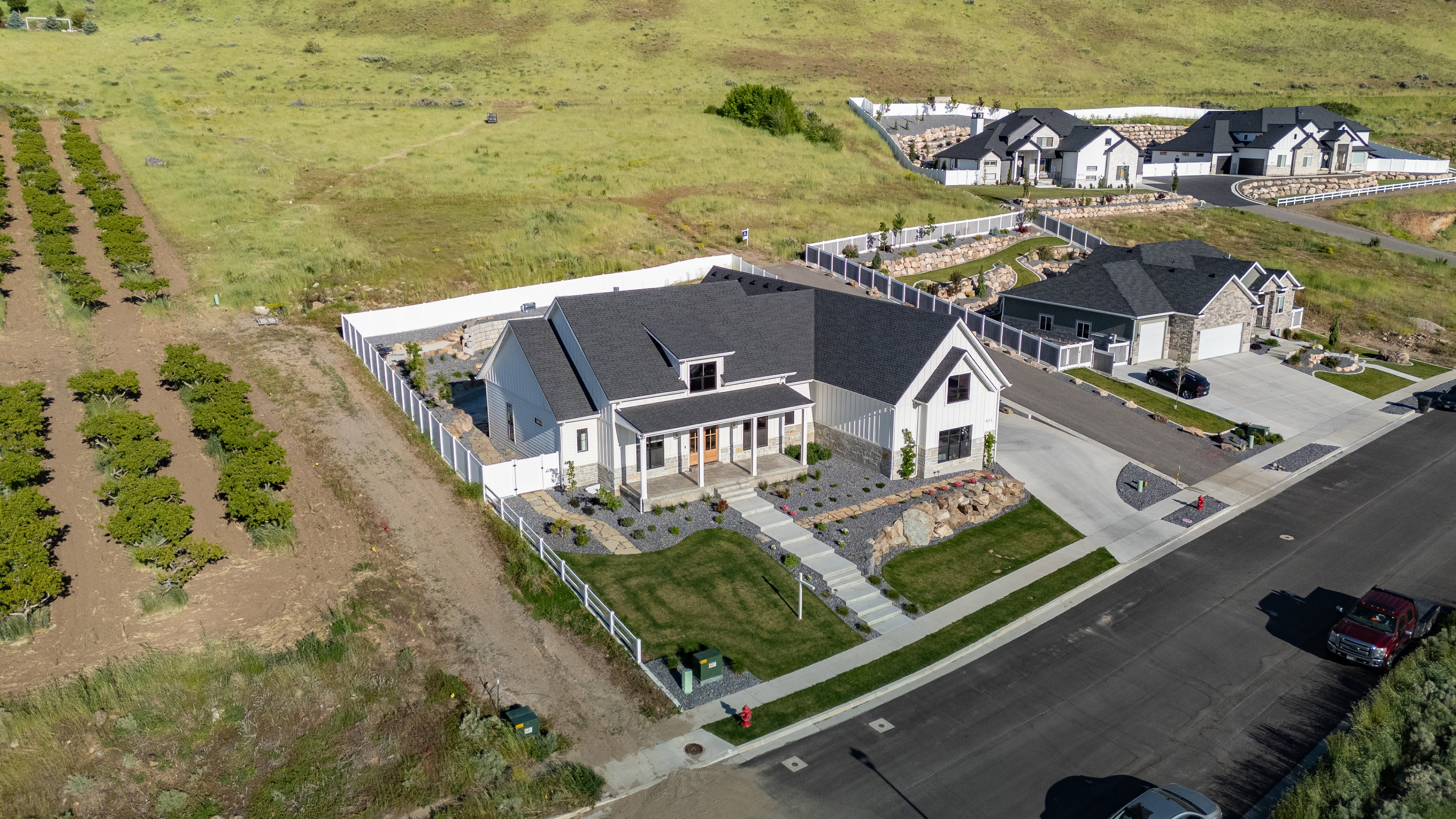 Modern farmhouse-style residence featuring a prominent covered porch and gabled roofline