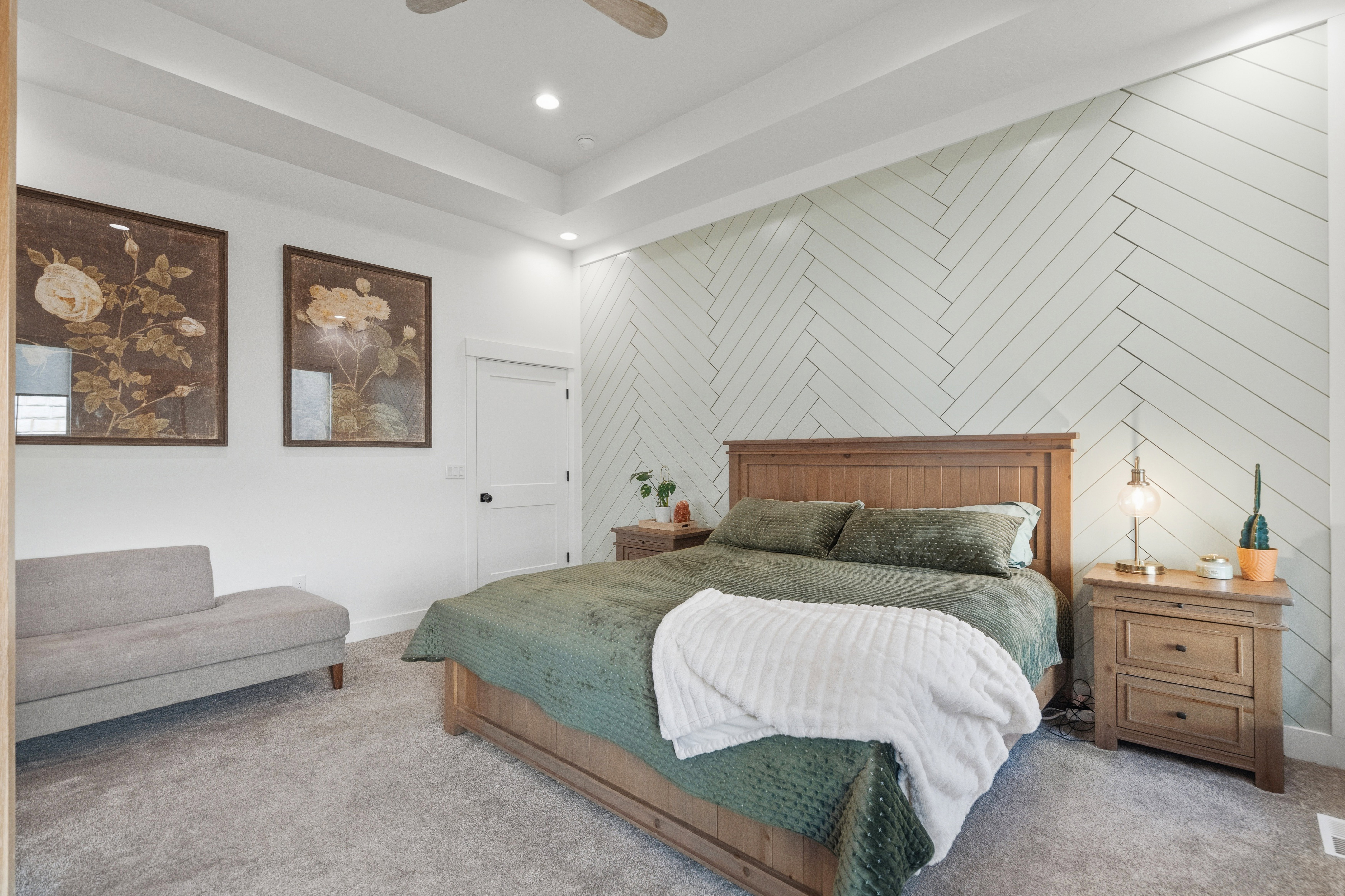 Herringbone accent wall featuring recessed lighting and a tray ceiling