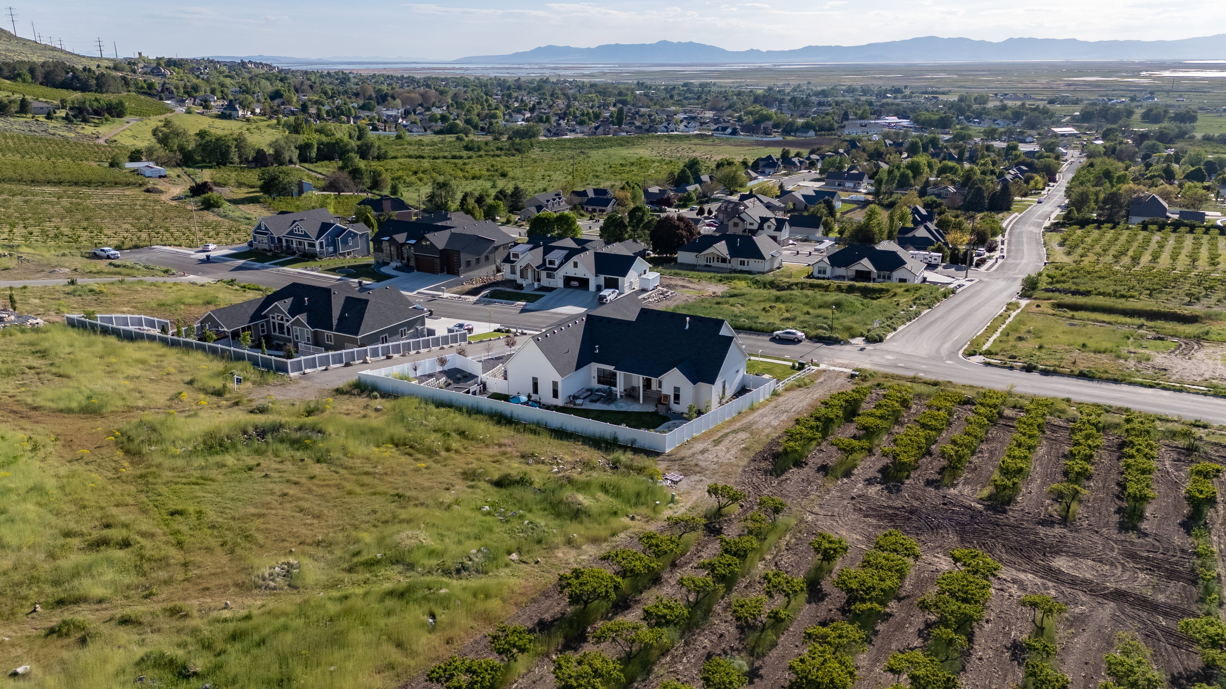 Aerial perspective showcasing a residential neighborhood with a distant mountain backdrop