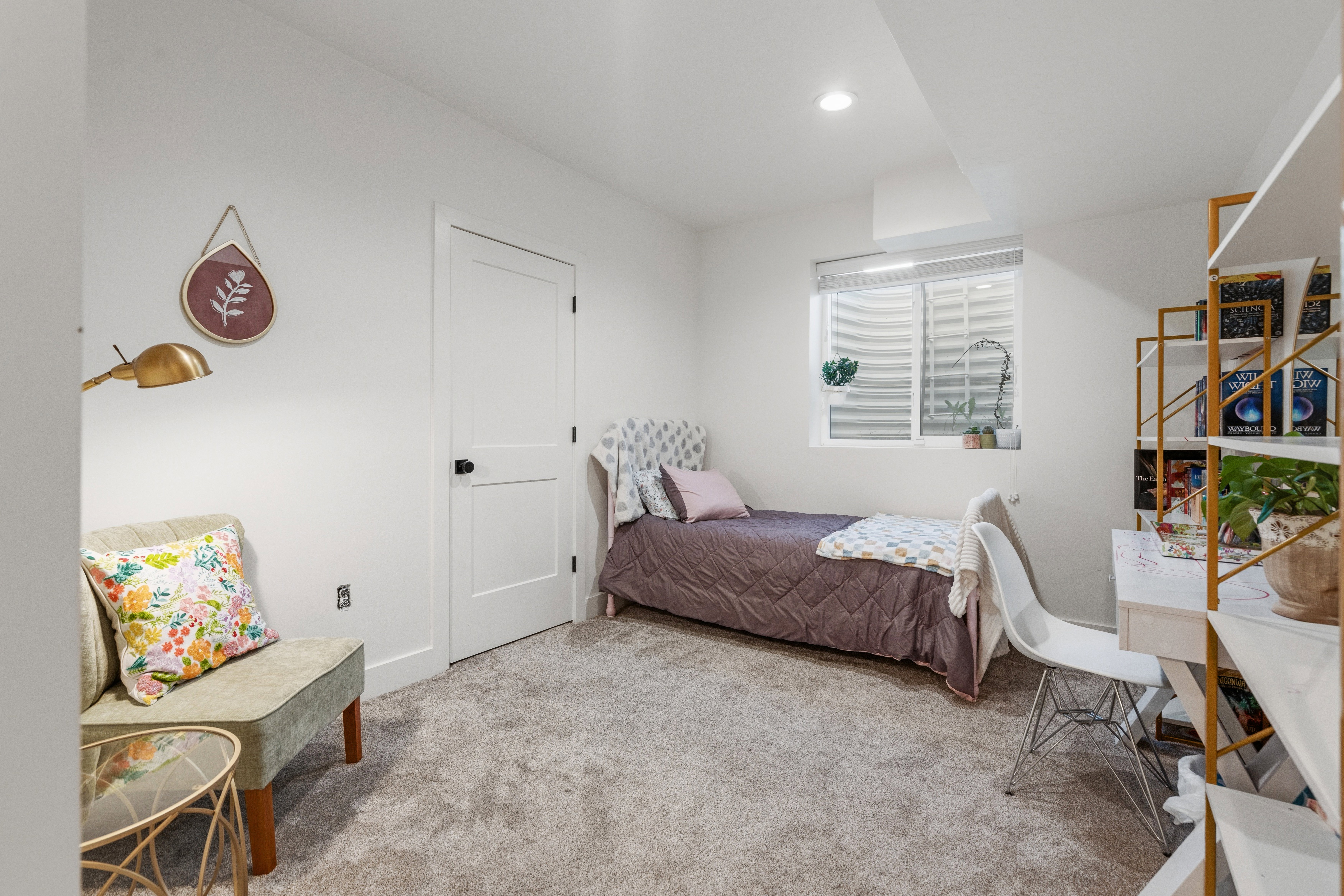 Carpeted room with a white door, recessed lighting, and a well window featuring horizontal blinds