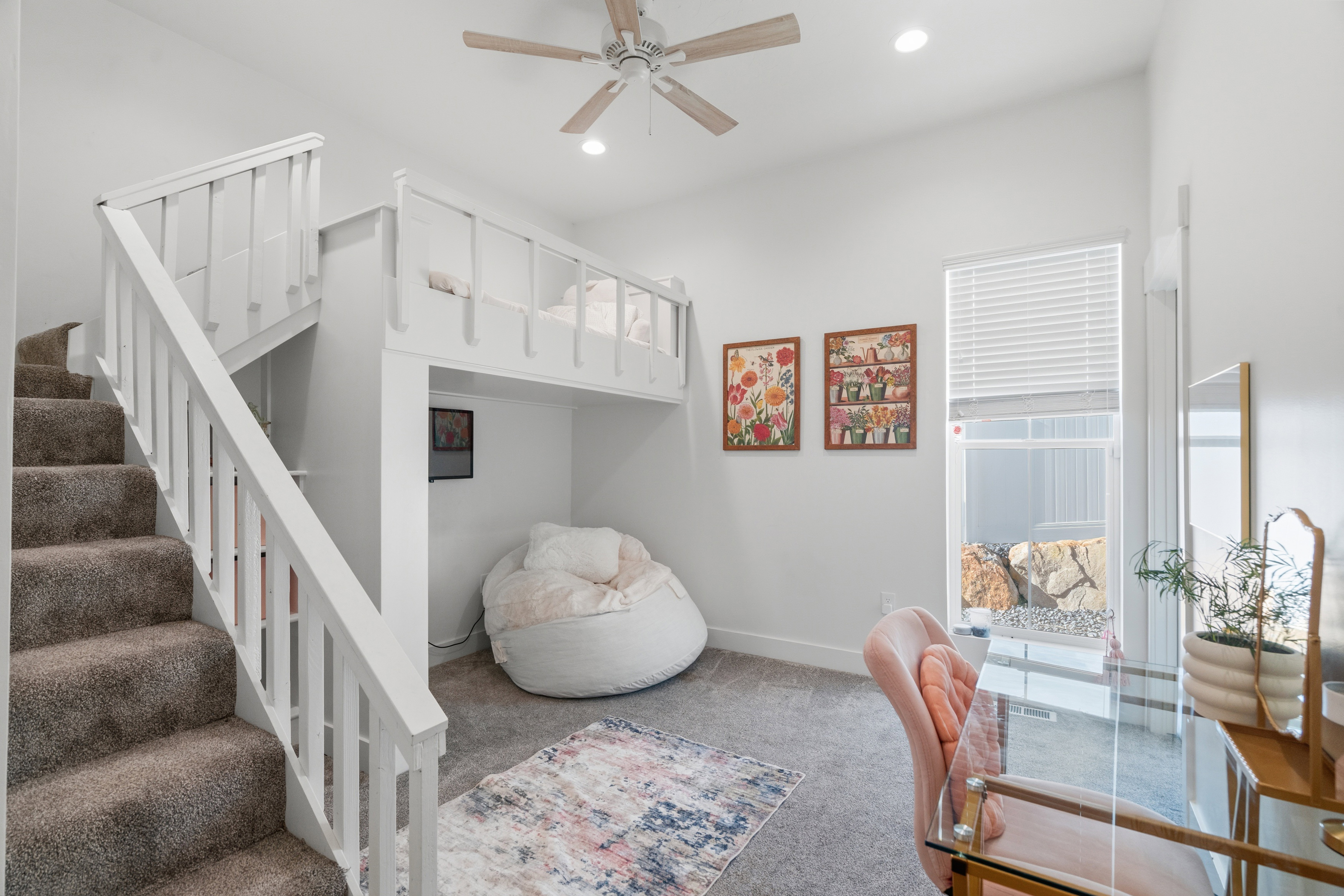 Carpeted staircase with white railings
