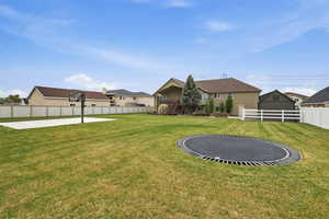 Expansive green lawn with an in-ground trampoline