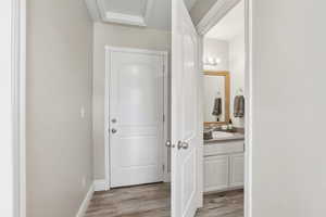 Contemporary bathroom with a single vanity, undermount sink, and wood-finish flooring