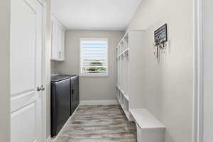 Dedicated mudroom with built-in cubbies and bench seating