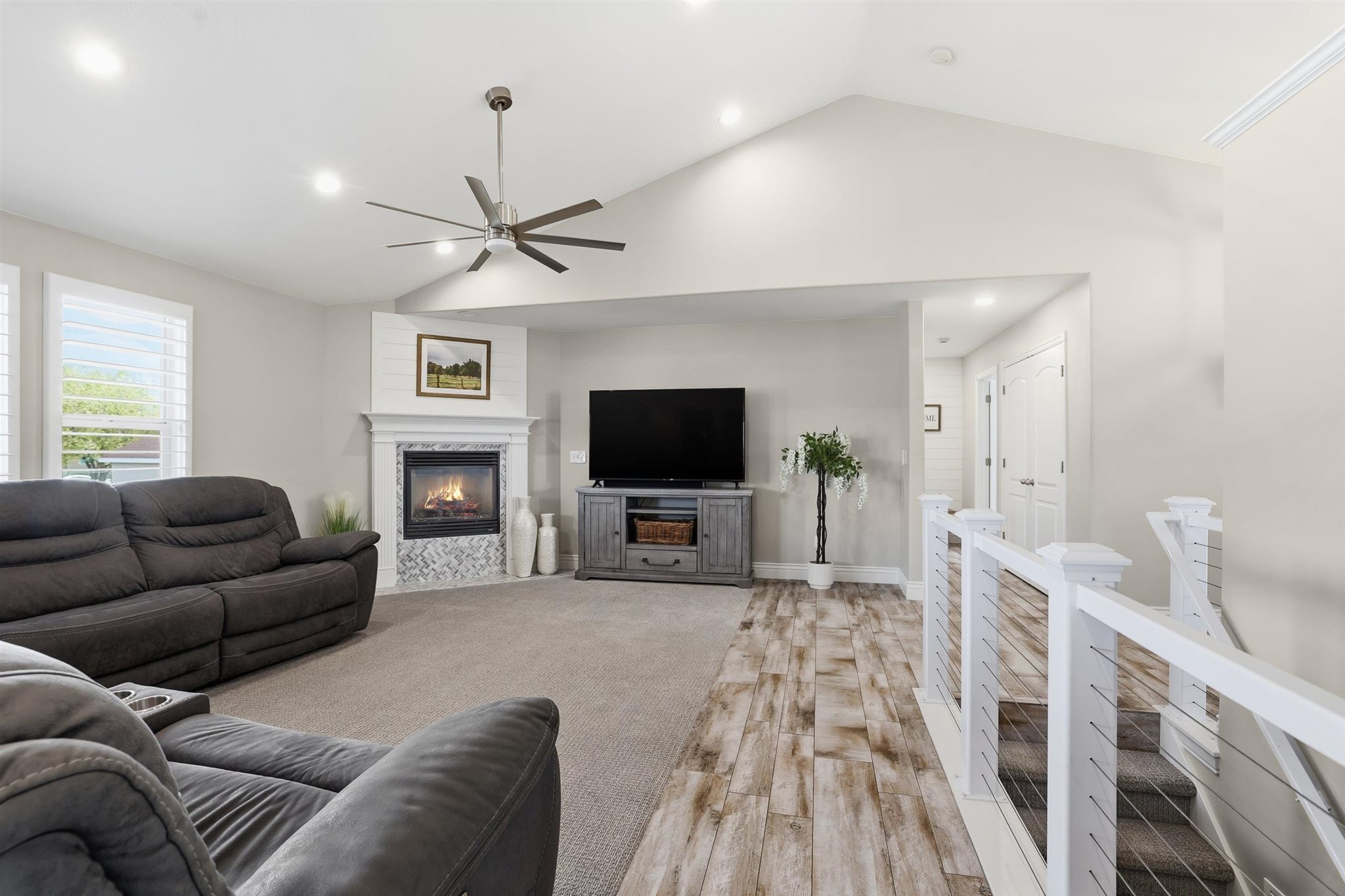 Living area featuring a vaulted ceiling with a ceiling fan and recessed lighting