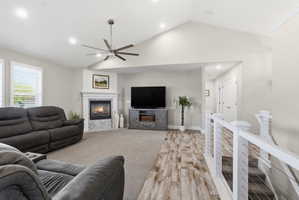 Living area featuring a vaulted ceiling with a ceiling fan and recessed lighting