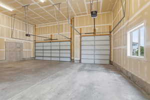 Spacious two-car garage featuring two individual garage doors with automatic openers