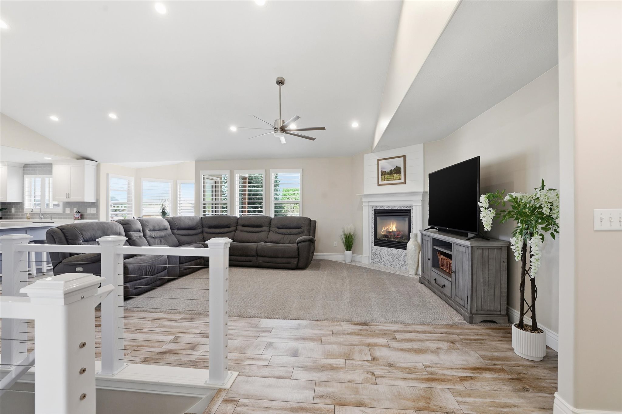 Spacious living area featuring high ceilings, recessed lighting, and wood-finish flooring
