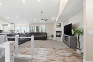 Spacious living area featuring high ceilings, recessed lighting, and wood-finish flooring
