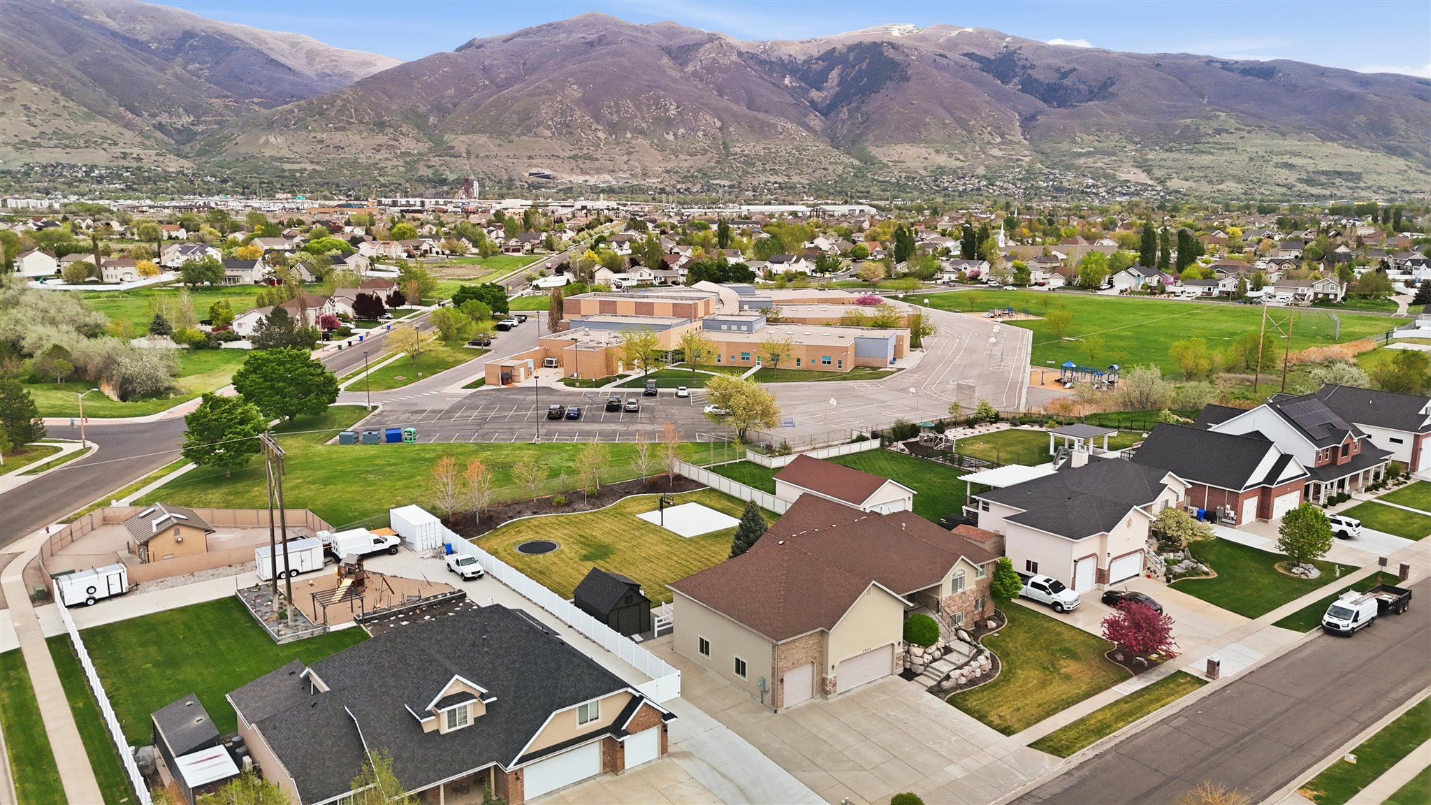 Expansive suburban neighborhood featuring multiple single-family residences with attached garages, manicured lawns, and varied architectural styles