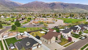 Expansive suburban neighborhood featuring multiple single-family residences with attached garages, manicured lawns, and varied architectural styles