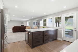 Kitchen island with dark wood-finish cabinetry and a white countertop