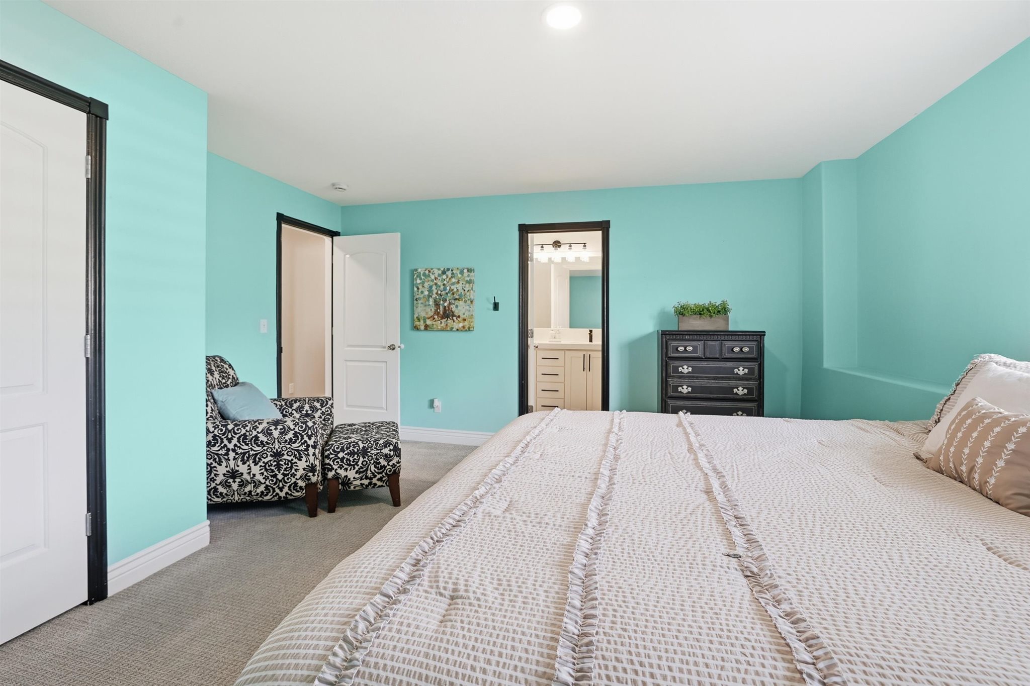 Spacious room featuring light blue walls, white trim, and light gray carpet