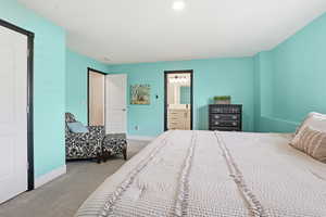 Spacious room featuring light blue walls, white trim, and light gray carpet
