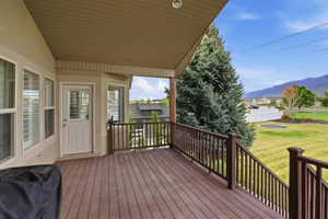 Spacious elevated deck featuring wood-finish flooring and dark wood railings