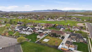 Residential neighborhood featuring a variety of single-family homes with diverse architectural styles, surrounded by green spaces and distant mountains