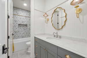 Bathroom vanity featuring a single undermount sink with a chrome faucet, light-toned countertop, and Taiga green shaker-style cabinetry with brass hardware