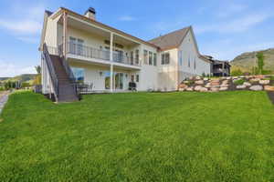 Expansive green lawn with a multi-level white stucco exterior