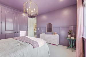 Bedroom featuring board and batten wall detailing, recessed lighting, and a decorative chandelier