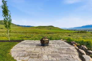 Firepit area featuring irregular flagstone pavers and showcasing sprawling mountain and valley views