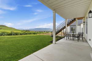 Covered patio with a concrete surface, supported by white pillars