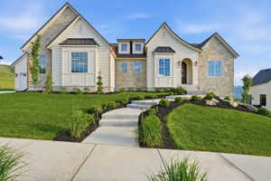 Stone and siding exterior featuring multiple gables and dormer windows