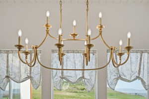 Ornate gold-tone chandelier with multiple candle-style lights