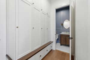 Mudroom featuring floor-to-ceiling cabinets