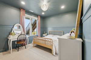 Carpeted room with beadboard wainscoting and a recessed ceiling light fixture