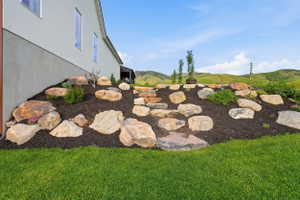 Terraced landscape design featuring natural stone and dark mulch
