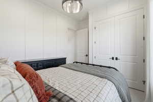 Interior space featuring extensive vertical wall paneling, a semi-flush mount ceiling light fixture, and white painted doors with matte black hardware