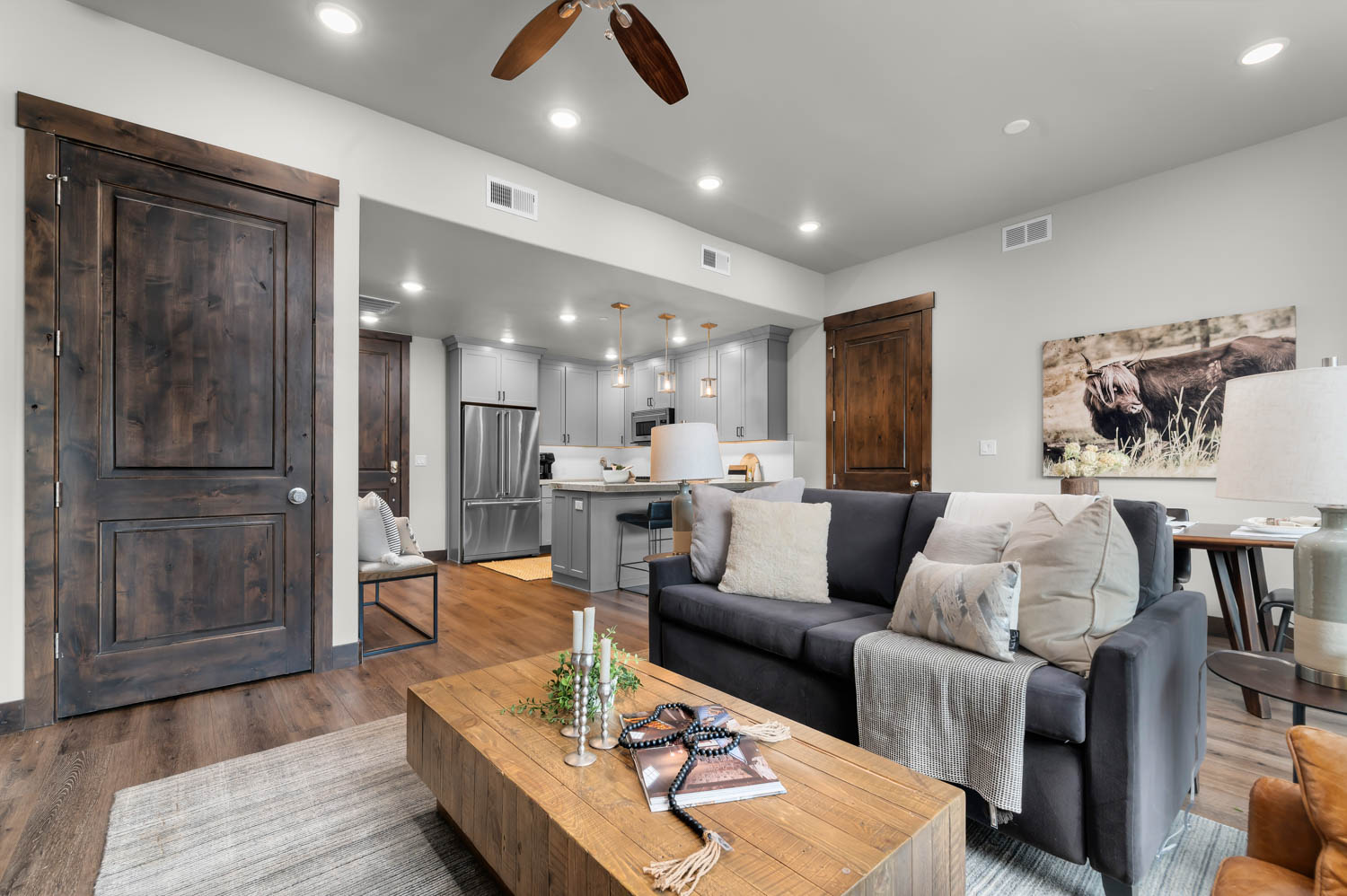 Open-concept living area featuring wood-finish flooring, recessed lighting, and a ceiling fan
