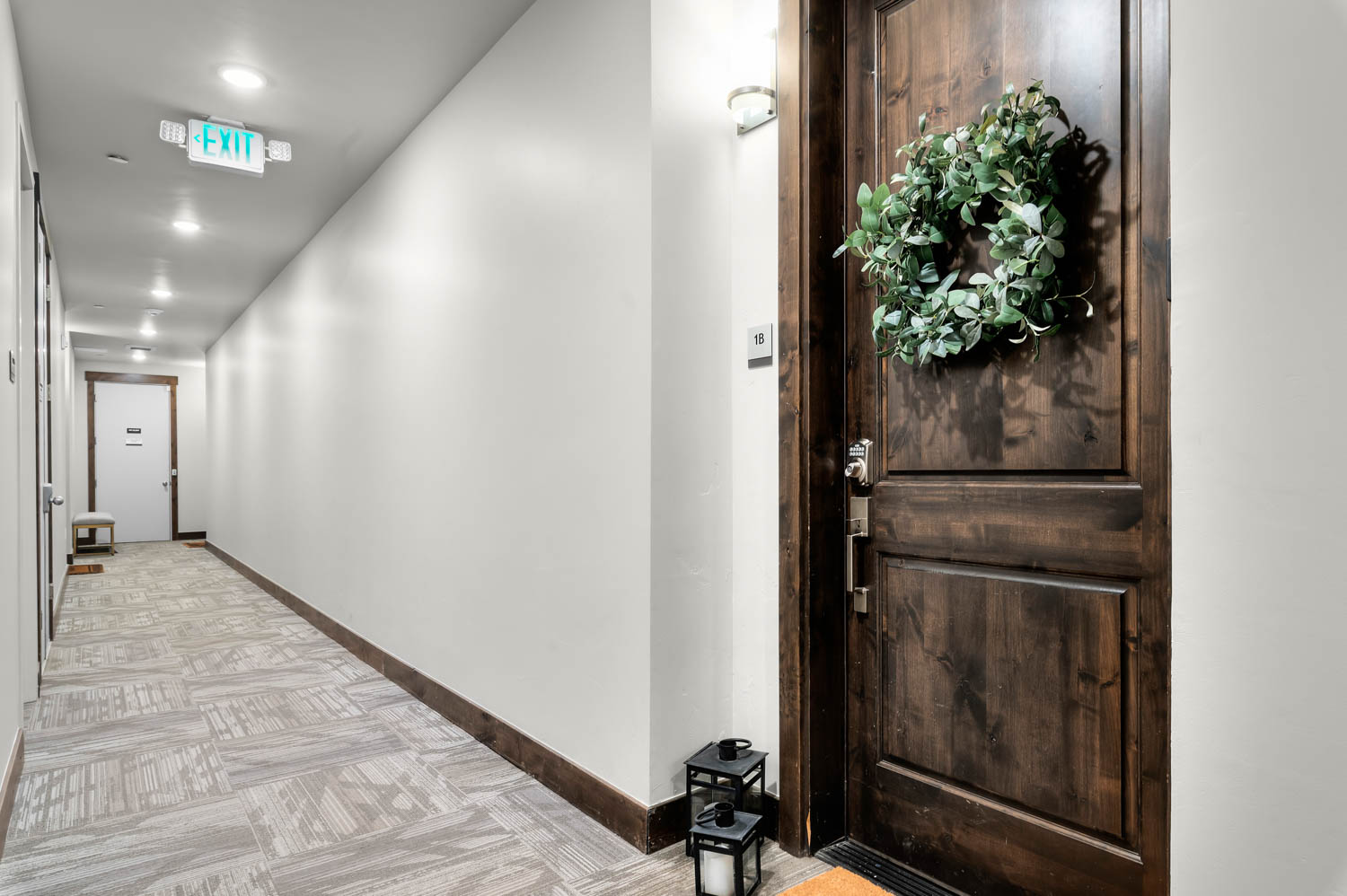 Rich wood-panel entry door featuring decorative hardware