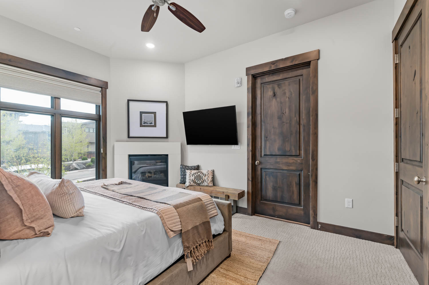 Interior space featuring a built-in fireplace, a ceiling fan with integrated lighting, recessed lighting, and large windows with dark wood trim