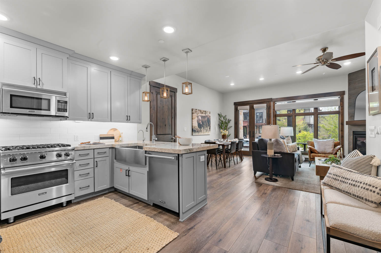Open-concept living space with wood-finish flooring