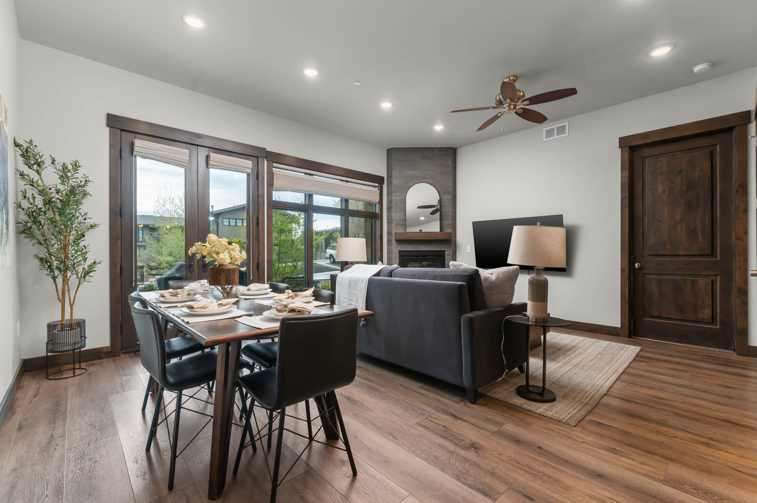 Open-concept living space featuring wood-finish flooring, recessed lighting, and a dark wood trim package