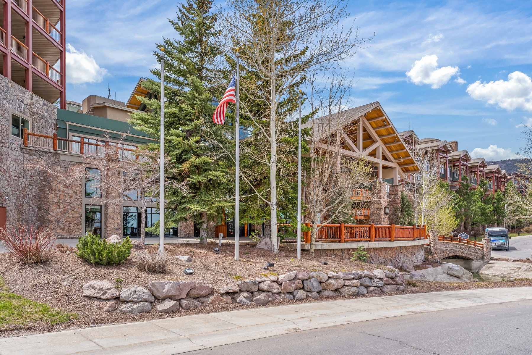 Stone-clad building exterior featuring a prominent gabled roofline with exposed timber trusses