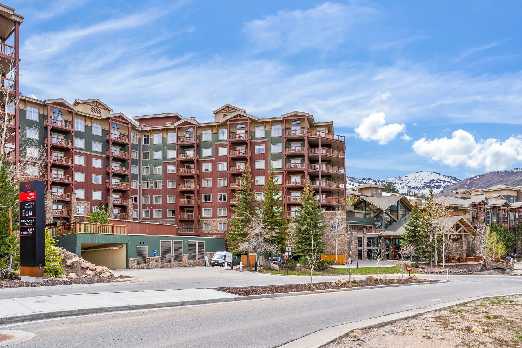 Multi-story condominium building featuring numerous private balconies