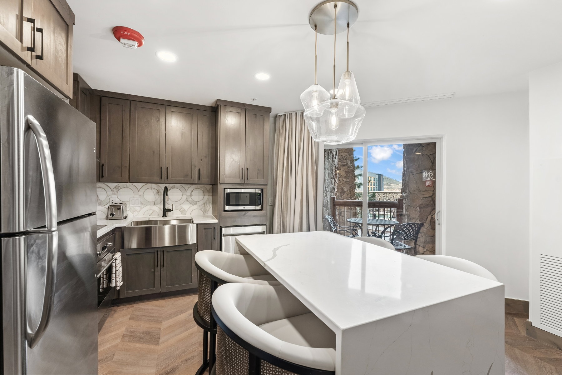 Modern kitchen featuring wood-finish flooring in a herringbone pattern