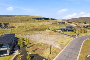 Developing hillside landscape with paved roads and scattered residential structures