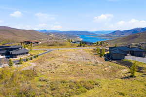 Expansive hillside land parcel featuring a paved road frontage