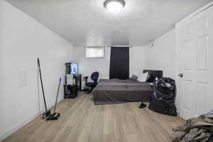 Light wood-finish flooring complements white walls in this interior space