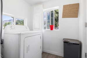 Dedicated laundry area with a white washing machine and dryer set