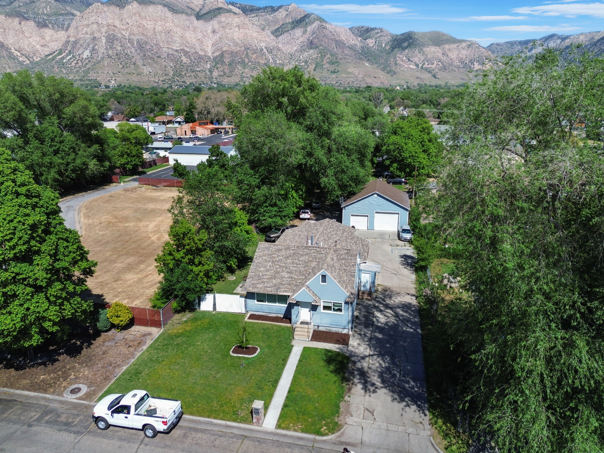 Aerial perspective showcasing a single-family residence with a detached garage